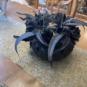 Halloween candle center piece. Base is plastic and flowers are black artificial.